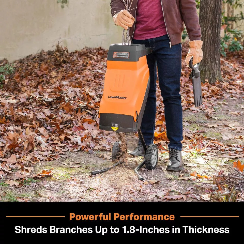 Person using a LawnMaster leaf shredder in an outdoor setting with leaves on the ground.