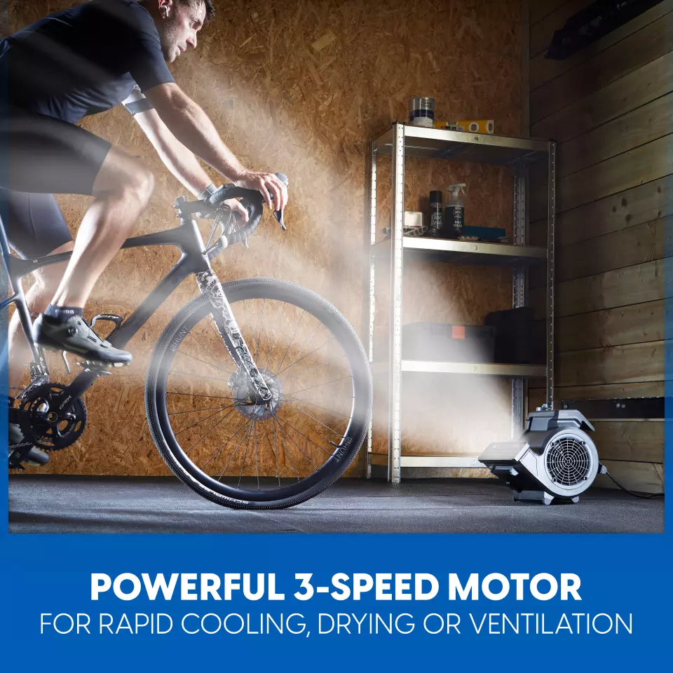 Person riding a bike in a garage with a powerful 3-speed motor device on a shelf.