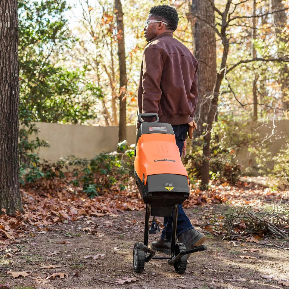 Man using a leaf blower in a wooded area