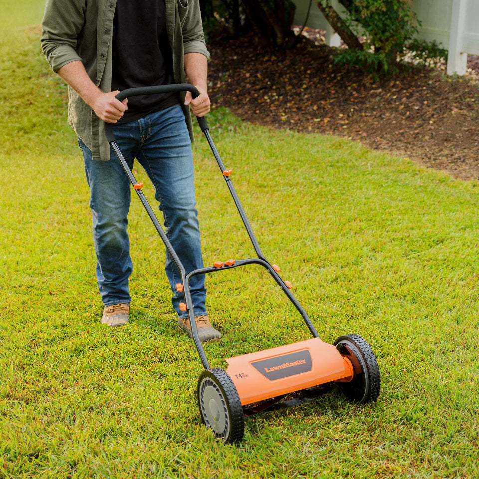 Person using a push lawn mower on a grassy area