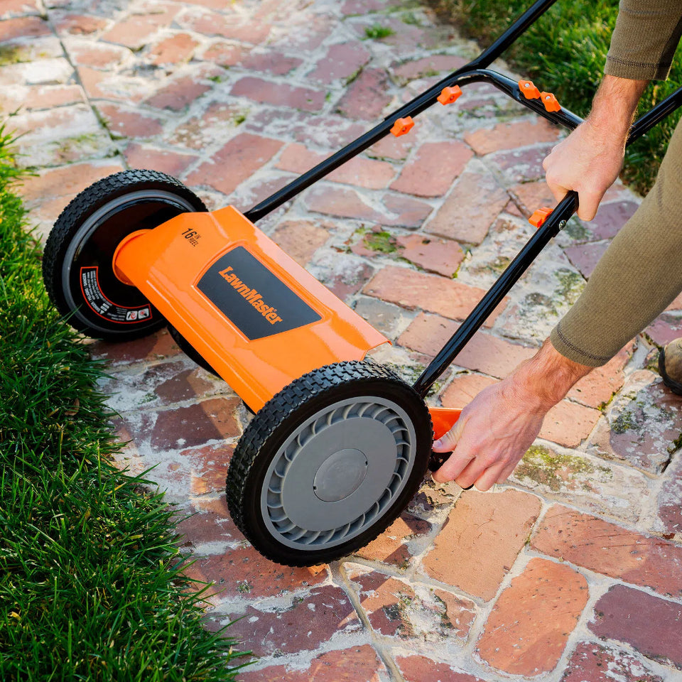 Person using a Lawn Doctor lawn edger on a brick patio