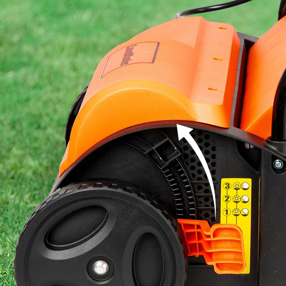 Close-up of an orange and black lawn mower on grass