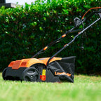 Orange and black Lawn mower on a grassy area with green bushes in the background