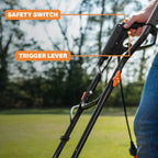 Close-up of a bow with labeled safety switch and trigger lever, outdoors.