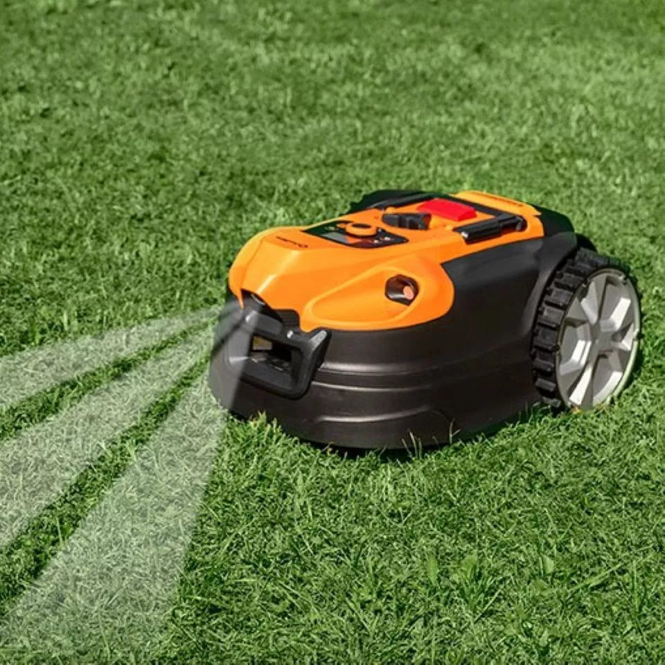 Robotic lawn mower on a green lawn