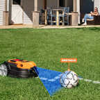 Robotic lawn mower on grass with a soccer ball labeled 'obstacle' nearby, in front of a house.