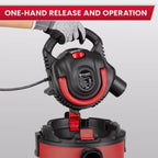Red and black extension cord reel with one-hand release feature on a gray background