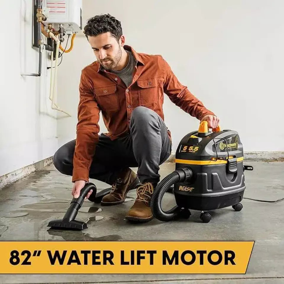 Man using a Black & Decker vacuum cleaner in a garage with '82” Water Lift Motor' text.