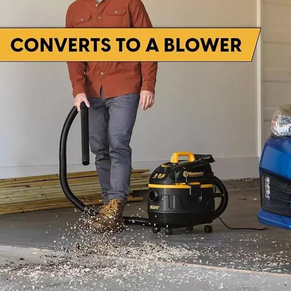 Person using a vacuum cleaner with a hose attachment in a garage setting, with text indicating it converts to a blower.
