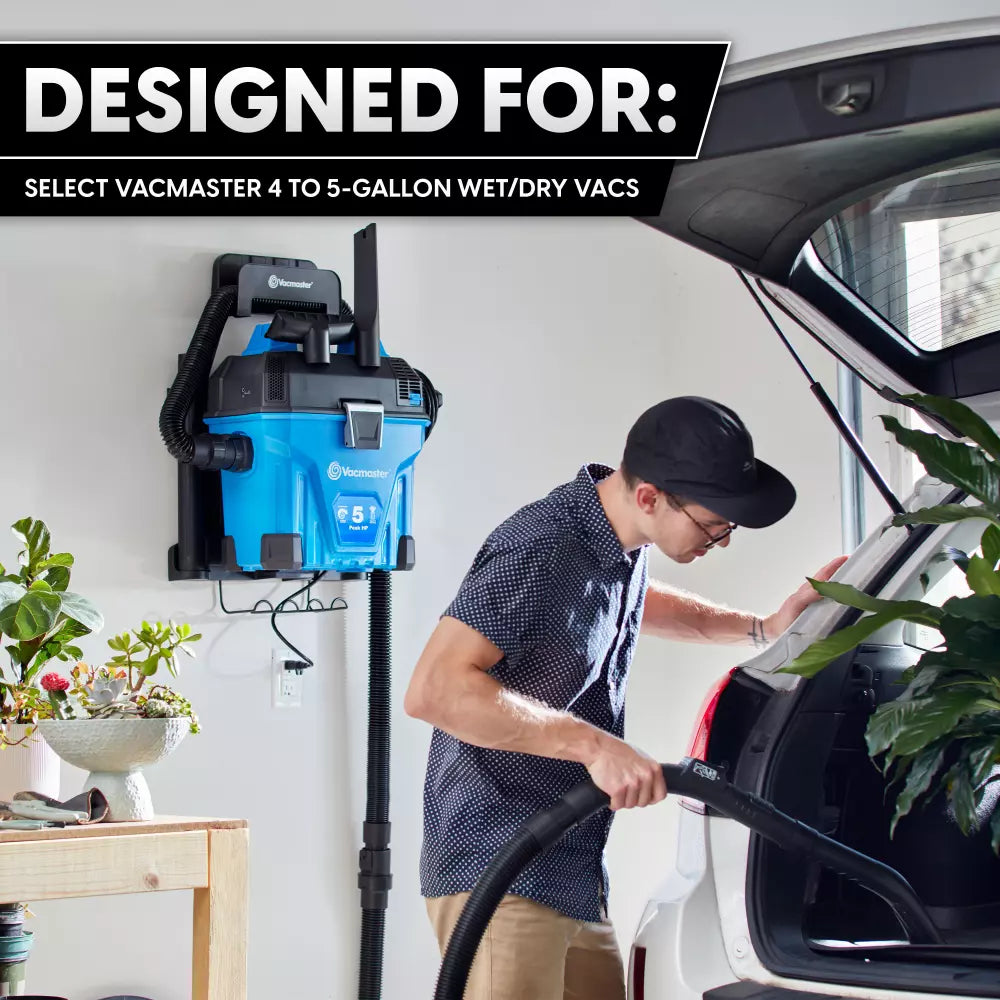 Person using a Vacmaster wet/dry vacuum cleaner in a home setting with text indicating compatibility.
