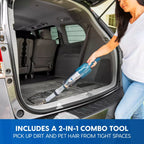 Person using a 2-in-1 combo tool to clean the back of a car.