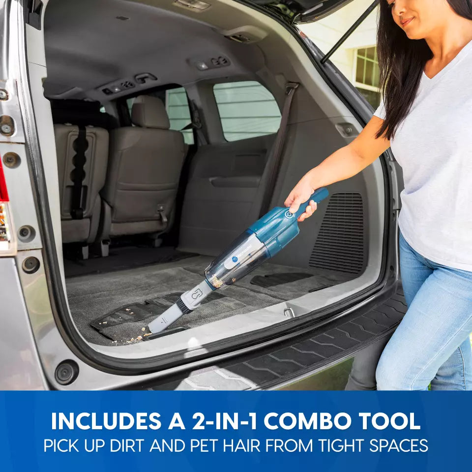 Person using a 2-in-1 combo tool to clean the back of a car.